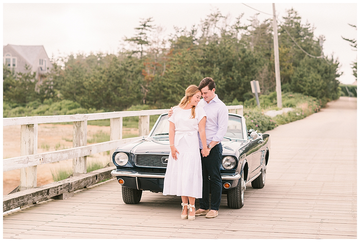 Rose and Ollie pose by a vintage mustang for their engagement photos