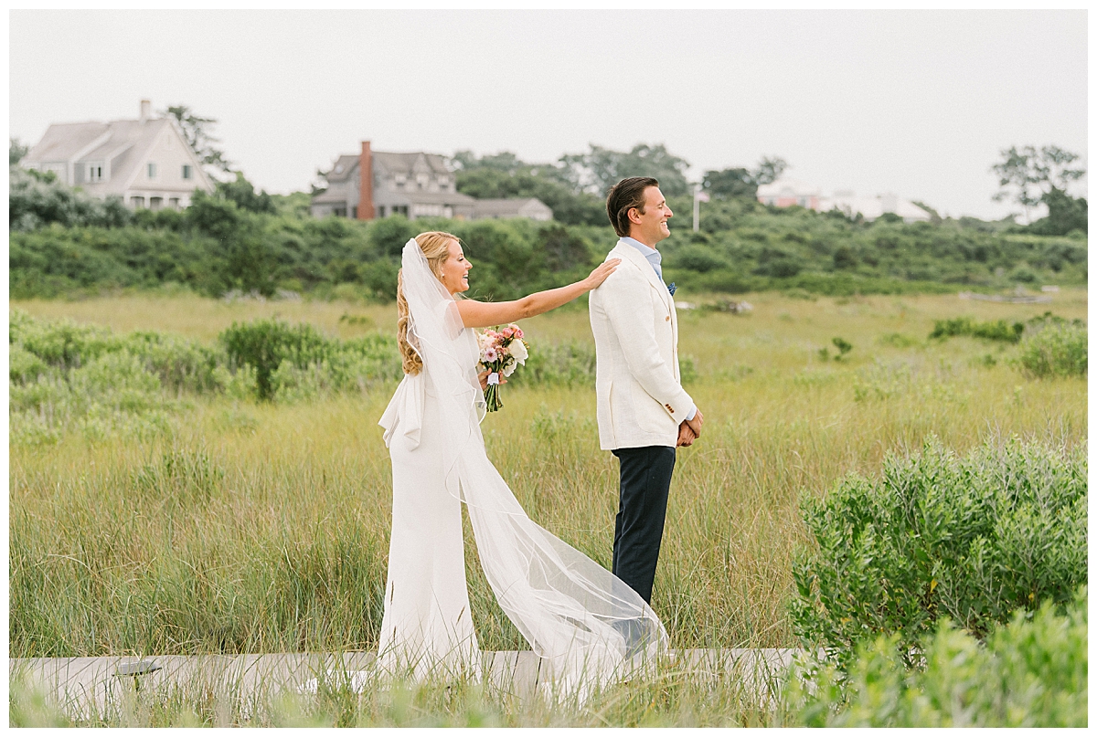 Liz taps Jared on the shoulder during their First look at their Wauwinet Micro Wedding on Nantucket