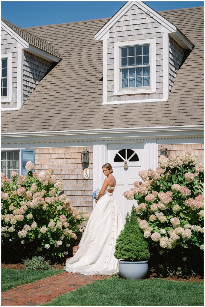 Kate standing in front of the house just before her Chatham Bars Inn wedding