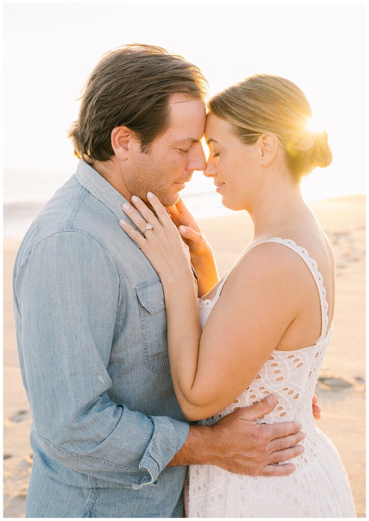 A beam of light shines behind Calista during their Nantucket engagement photos. 